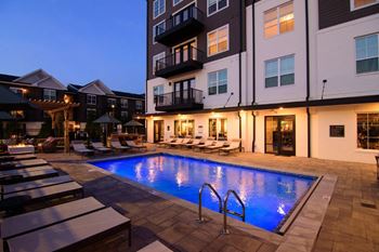 a swimming pool at night in front of an apartment building at Kendall Park Too, Columbus
